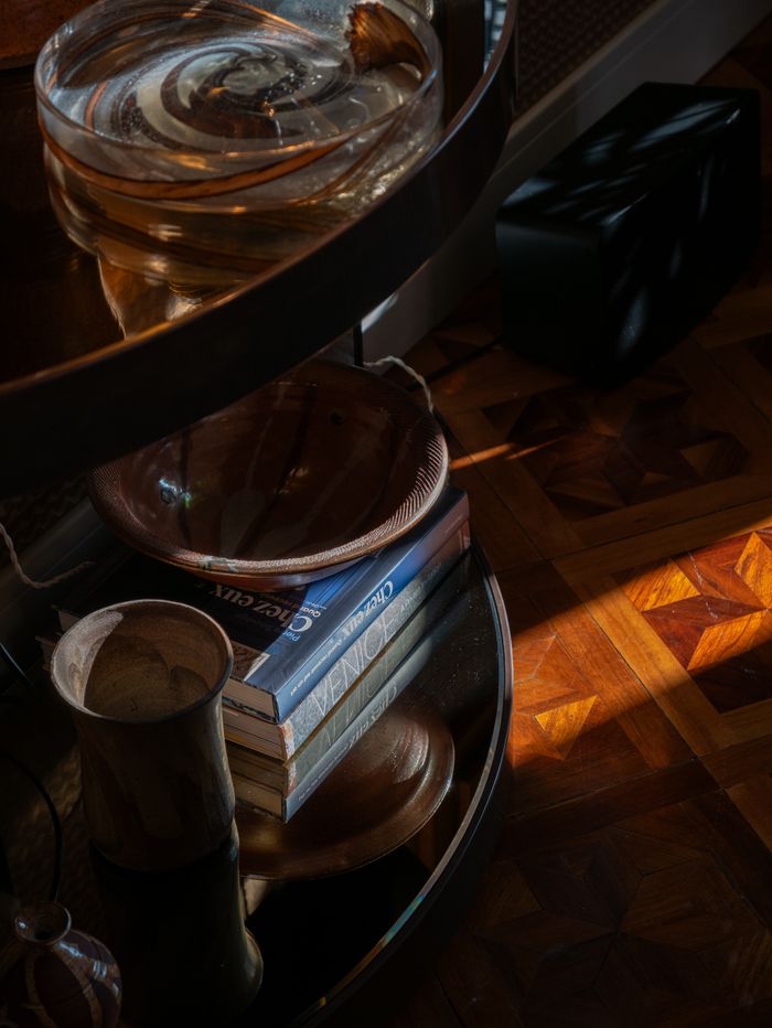 Warm and cozy indoor scene showcasing books, wooden bowls, and subtle natural light.